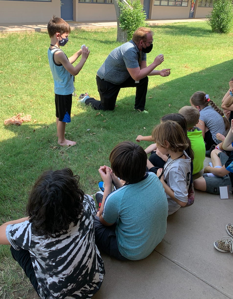 Mr. Tim explains cell structure with an egg after students have a chance to walk on eggs and discuss why they didn't break.